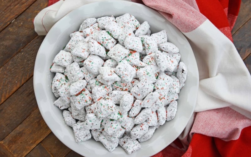 Christmas Puppy Chow transforms a traditional muddy buddy recipe into a festive Reindeer Chow mix! The perfect no-bake dessert for any party or event. #puppychow #reindeerchow #muddybuddy www.savoryexperiments.com