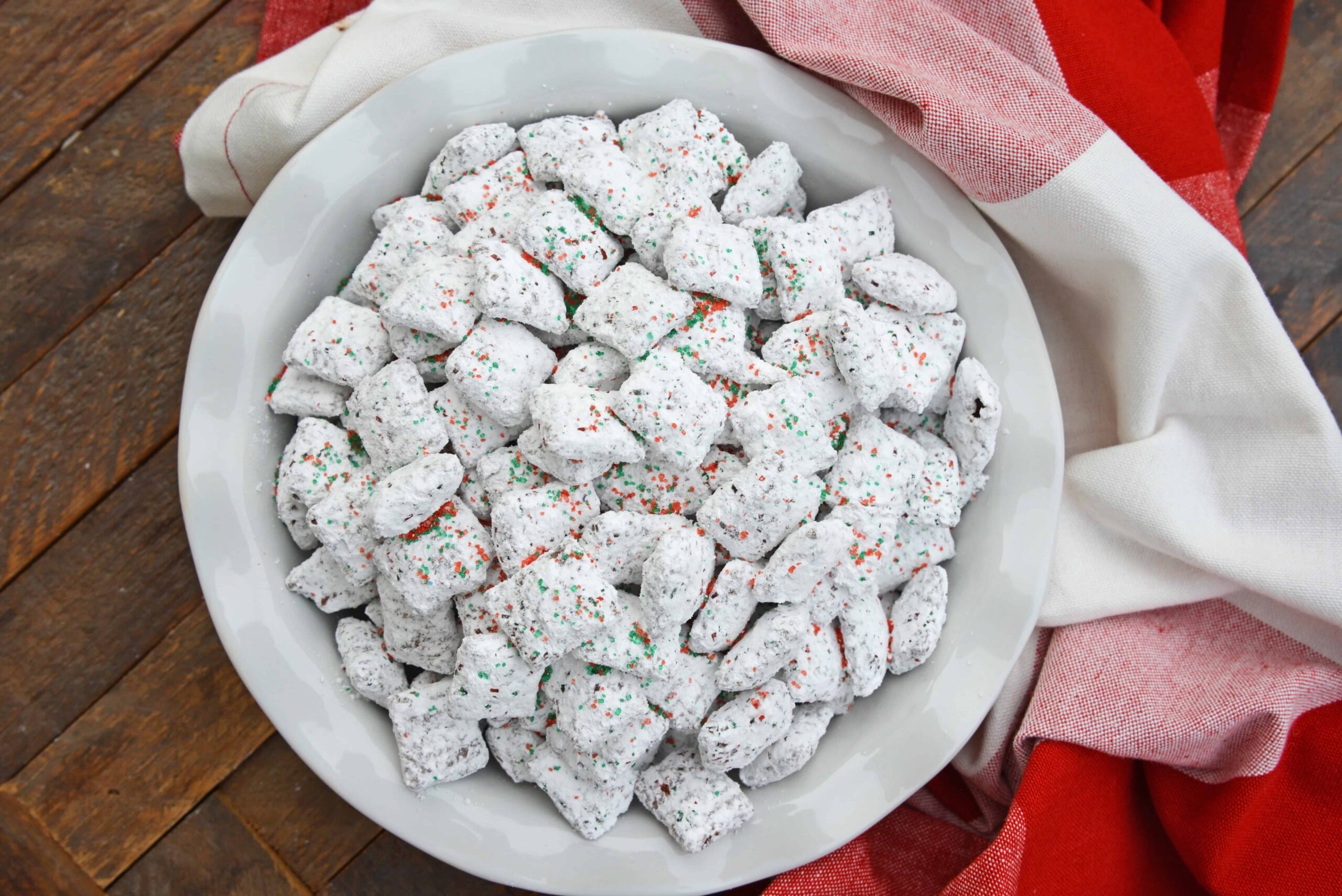 Christmas Puppy Chow transforms a traditional muddy buddy recipe into a festive Reindeer Chow mix! The perfect no-bake dessert for any party or event. #puppychow #reindeerchow #muddybuddy www.savoryexperiments.com