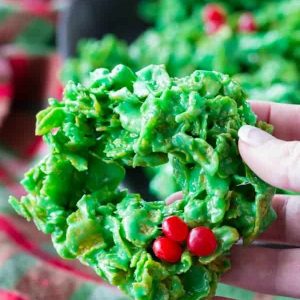Hand holding a no bake Christmas wreath cookie