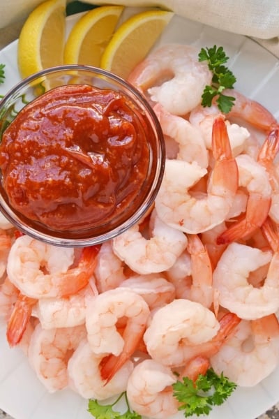 Shrimp Cocktail on a white plate with a small bowl of cocktail sauce