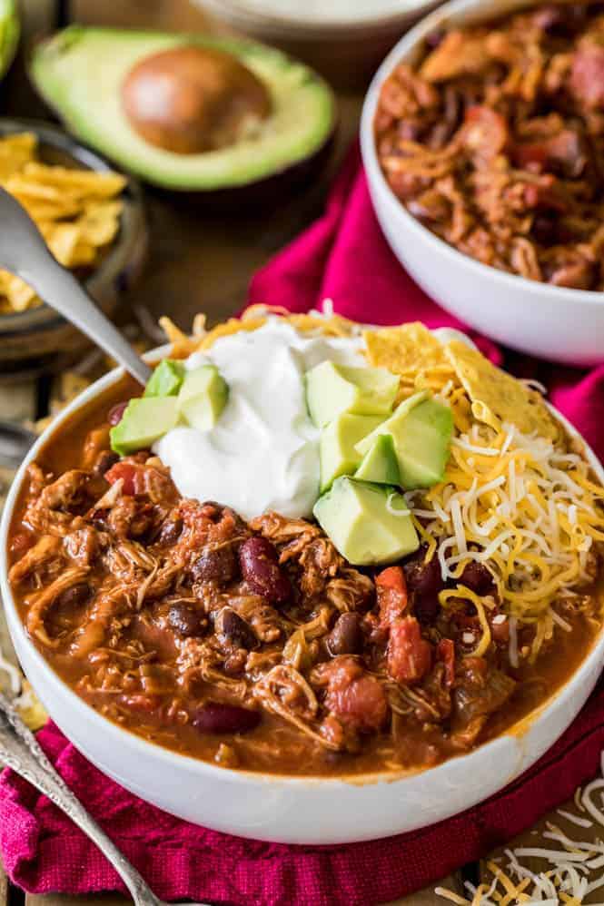 Turkey chili in a white bowl with sour cream and cheese - leftover turkey recipes