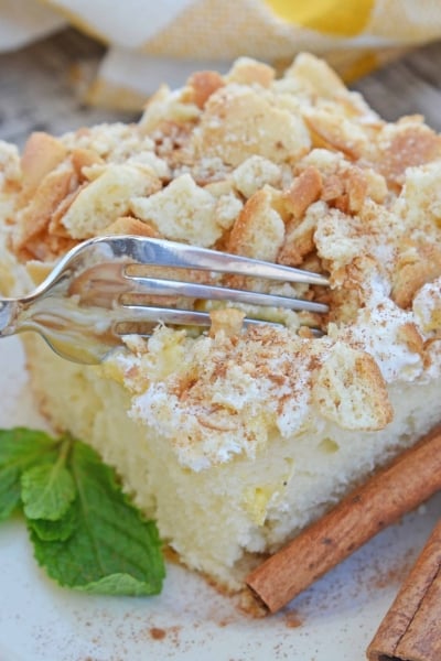 This Eggnog Poke Cake recipe is an easy pudding poke cake made with box cake mix and instant vanilla pudding, with delicious eggnog flavor. #pokecakerecipe #puddingpokecake #eggnogrecipes www.savoryexperiments.com