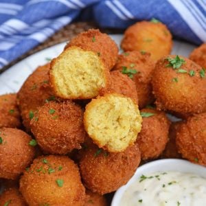Hush Puppies are gently fried cornbread with a crunchy outside and soft, doughy inside. Serve with fish fry, fried shrimp or any BBQ! #hushpuppyrecipe www.savoryexperiments.com