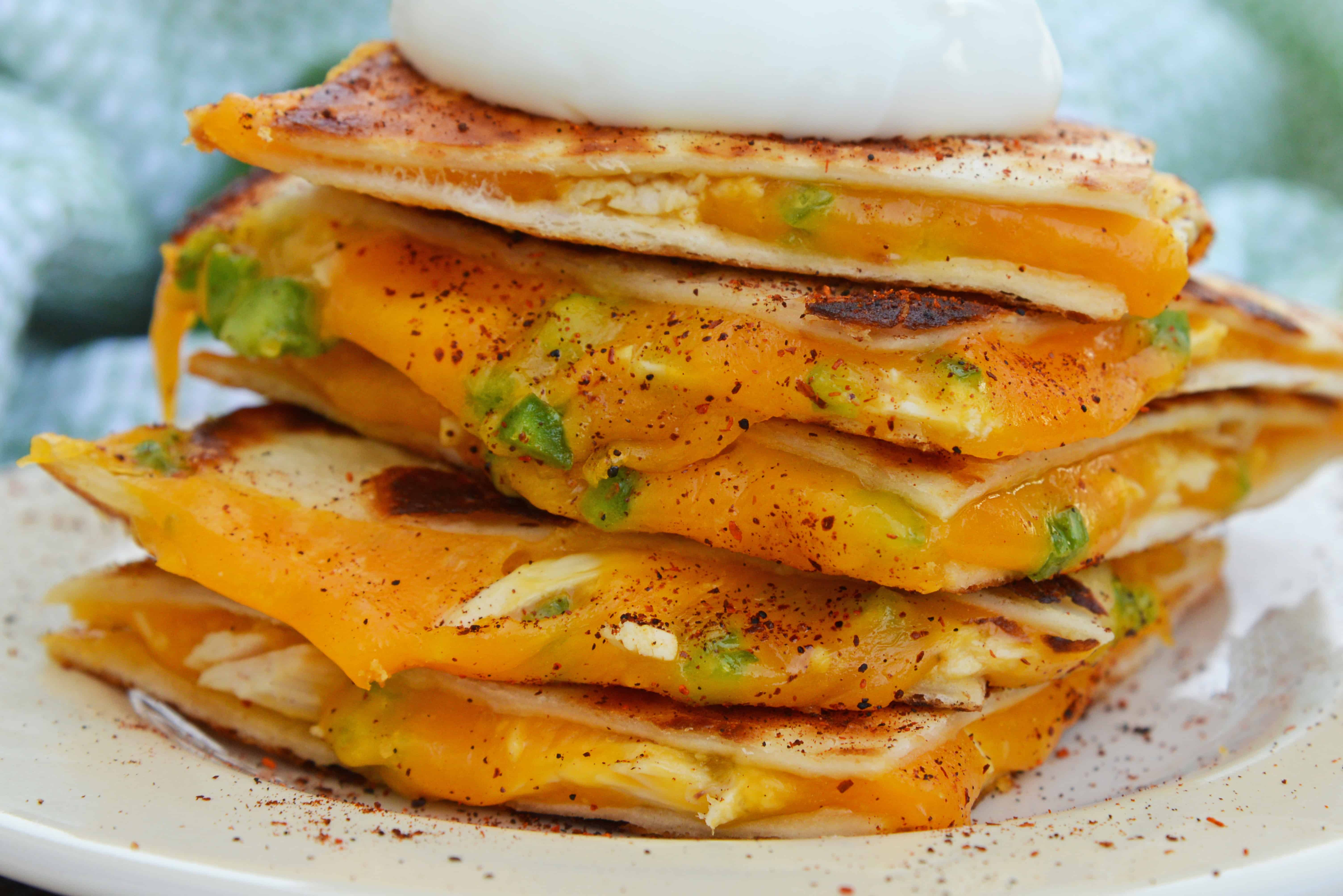 Cheesy, spicy and shareable Cheesy Jalapeño Quesadillas are the gooey appetizer everyone loves. Stacked with cheddar cheese, fresh jalapeños and shredded chicken, they are ready in just 10 minutes! #cheesequesadillas www.savoryexperiments.com