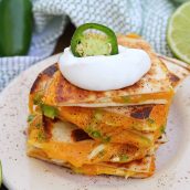 Cheesy, spicy and shareable Cheesy Jalapeño Quesadillas are the gooey appetizer everyone loves. Stacked with cheddar cheese, fresh jalapeños and shredded chicken, they are ready in just 10 minutes! #cheesequesadillas www.savoryexperiments.com