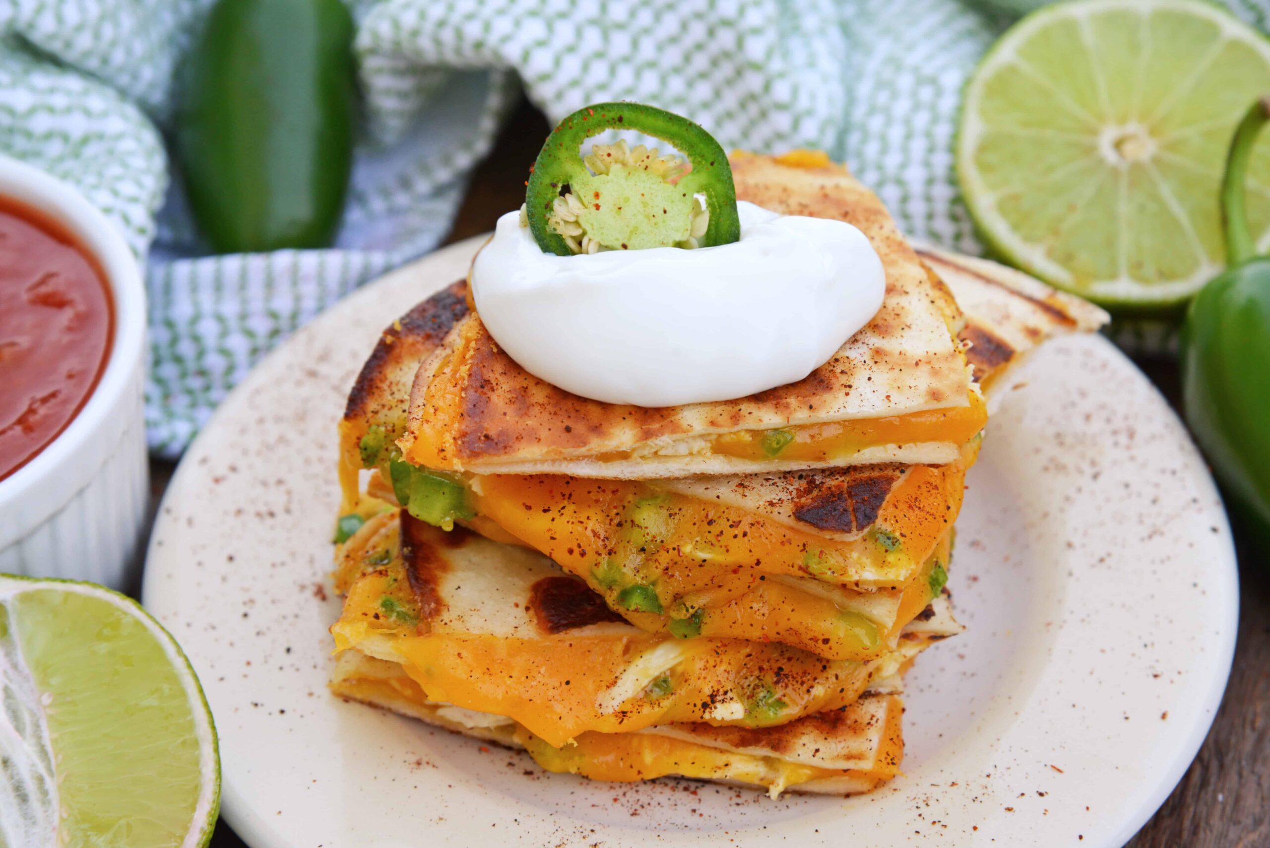 Cheesy, spicy and shareable Cheesy Jalapeño Quesadillas are the gooey appetizer everyone loves. Stacked with cheddar cheese, fresh jalapeños and shredded chicken, they are ready in just 10 minutes! #cheesequesadillas www.savoryexperiments.com