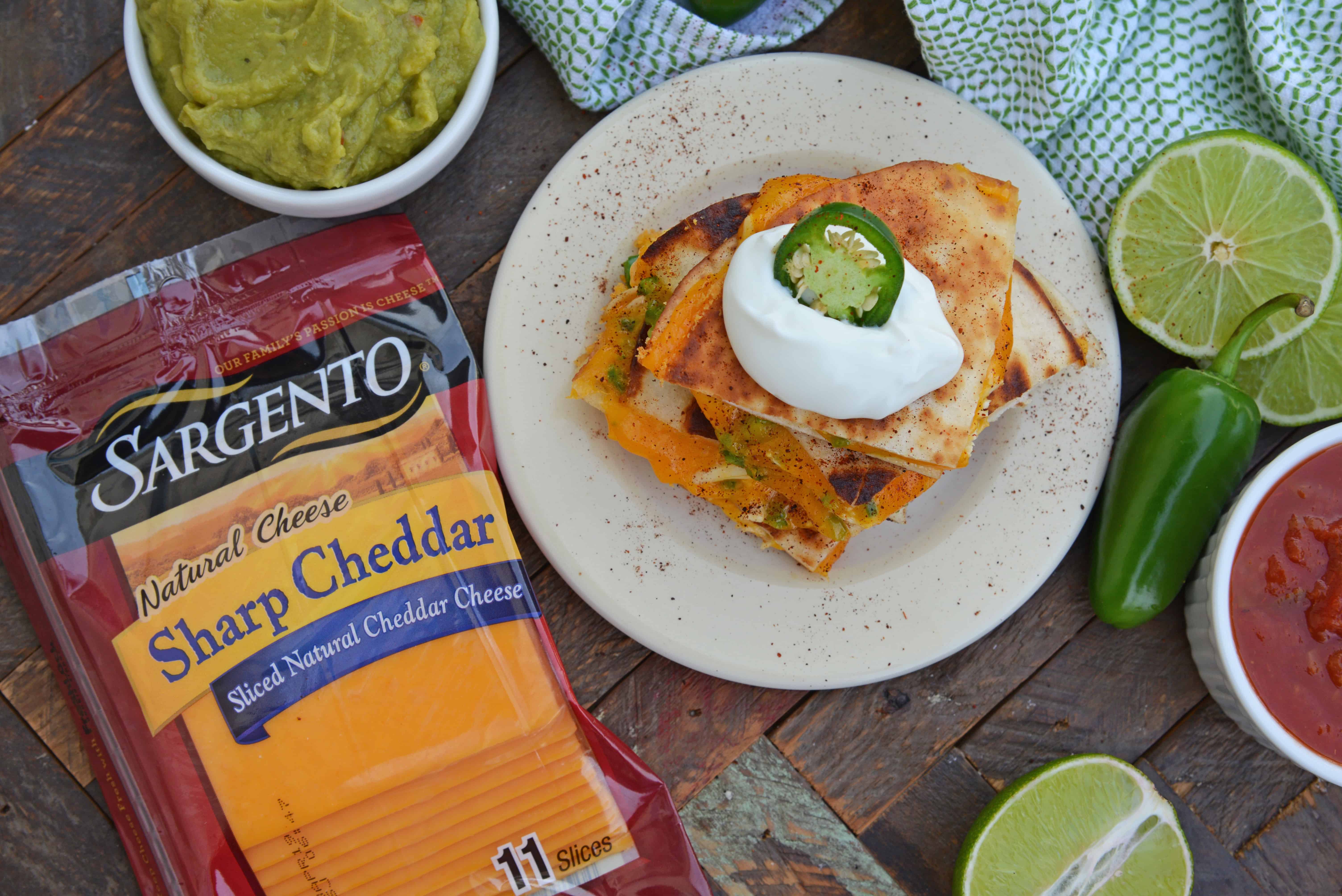 Cheesy, spicy and shareable Cheesy Jalapeño Quesadillas are the gooey appetizer everyone loves. Stacked with cheddar cheese, fresh jalapeños and shredded chicken, they are ready in just 10 minutes! #cheesequesadillas www.savoryexperiments.com