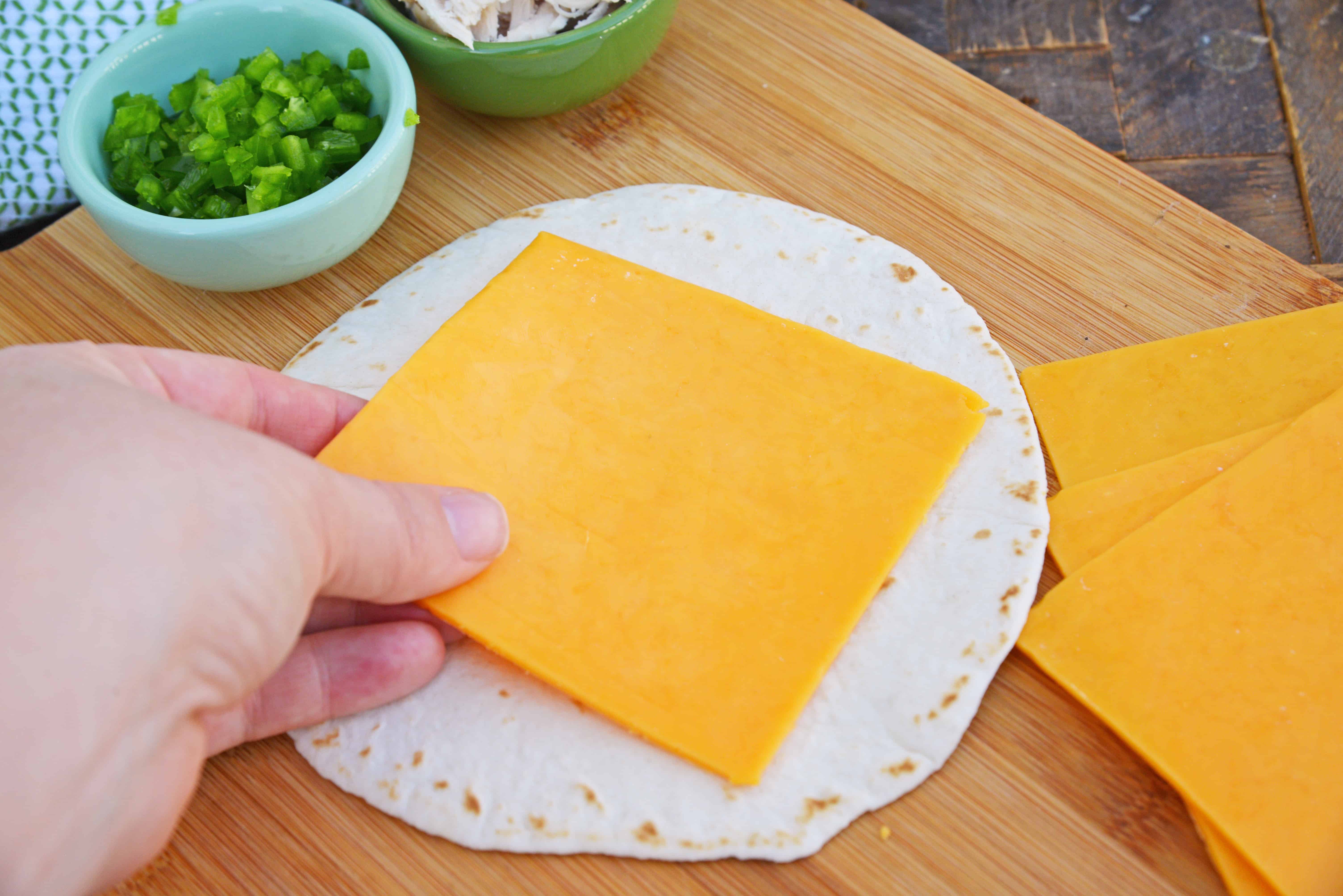 Cheesy, spicy and shareable Cheesy Jalapeño Quesadillas are the gooey appetizer everyone loves. Stacked with cheddar cheese, fresh jalapeños and shredded chicken, they are ready in just 10 minutes! #cheesequesadillas www.savoryexperiments.com