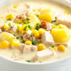 Turkey corn chowder in a white bowl - leftover turkey recipes