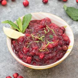 Thanksgiving sides mojito cranberry sauce in a white bowl with mint and lime