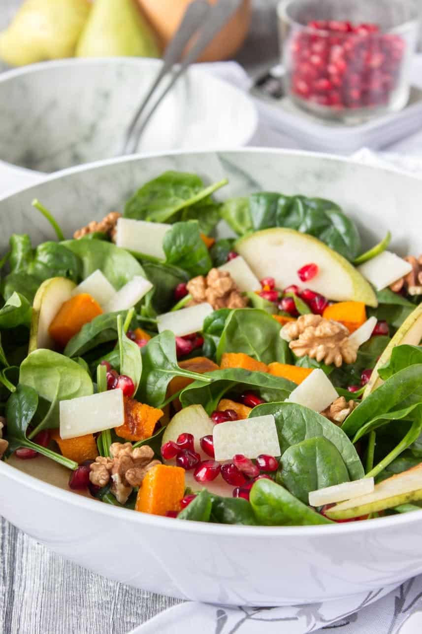 Thanksgiving sides roast pumpkin pear salad in a white bowl