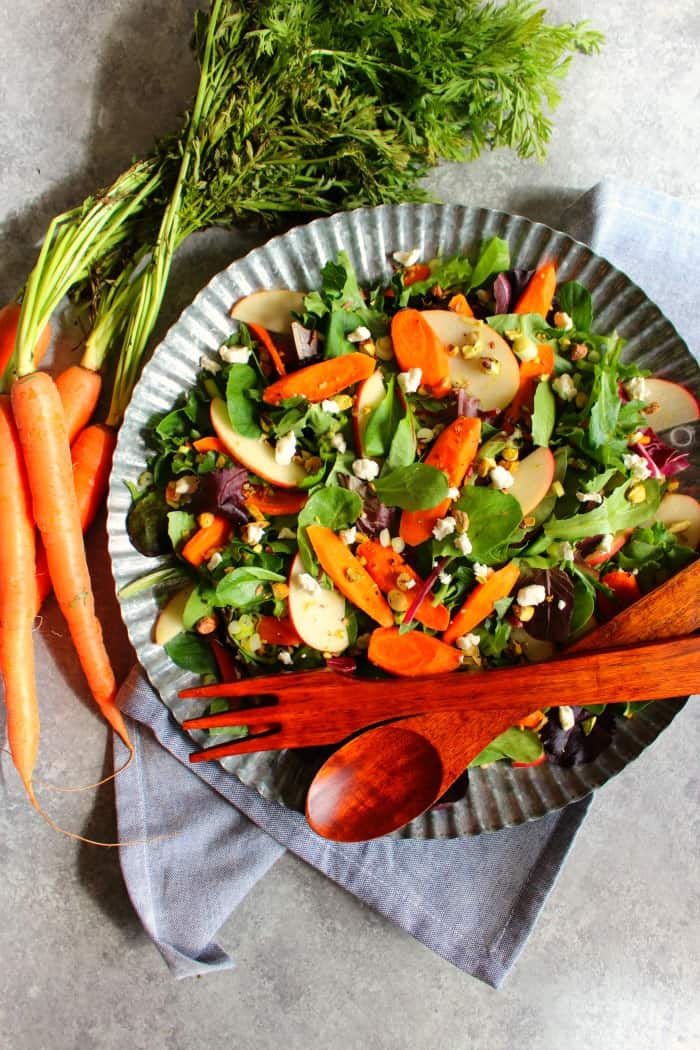 Thanksgiving sides carrot apple pistachio salad with wooden utensils