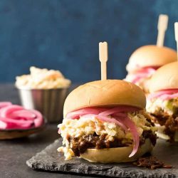 Slow cooker shredded beef slider sandwich recipes on a slate