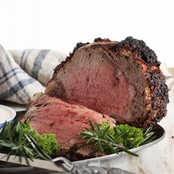 Standing rib roast sliced on a tray - Christmas main dishes