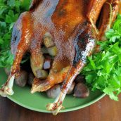 Sweet Roasted Goose is a tried and true recipe for a succulent goose with crispy skin and tender meat seasoned with apple, orange and potato stuffing. Top with Cumberland Sauce. #howtocookgoose #roastgoose www.savoryexperiments.com