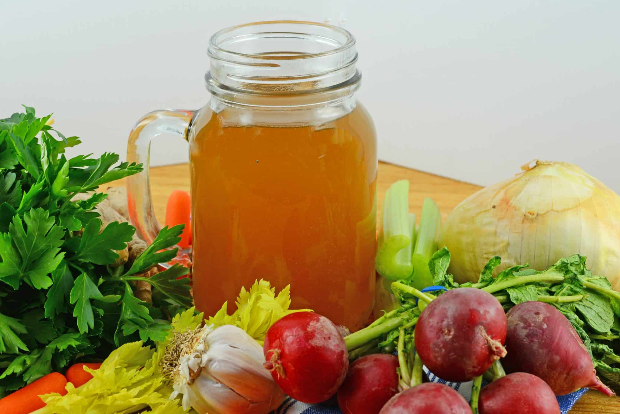 Turkey stock surrounded by vegetables, leftover turkey recipes