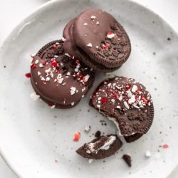 Christmas oreos broken on a white plate