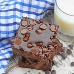 Stack of Flourless Black Bean Brownies with a glass of milk