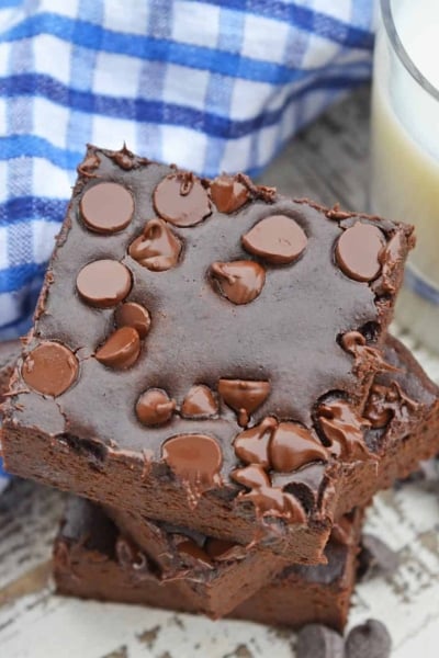 Stack of Flourless Black Bean Brownies with a glass of milk