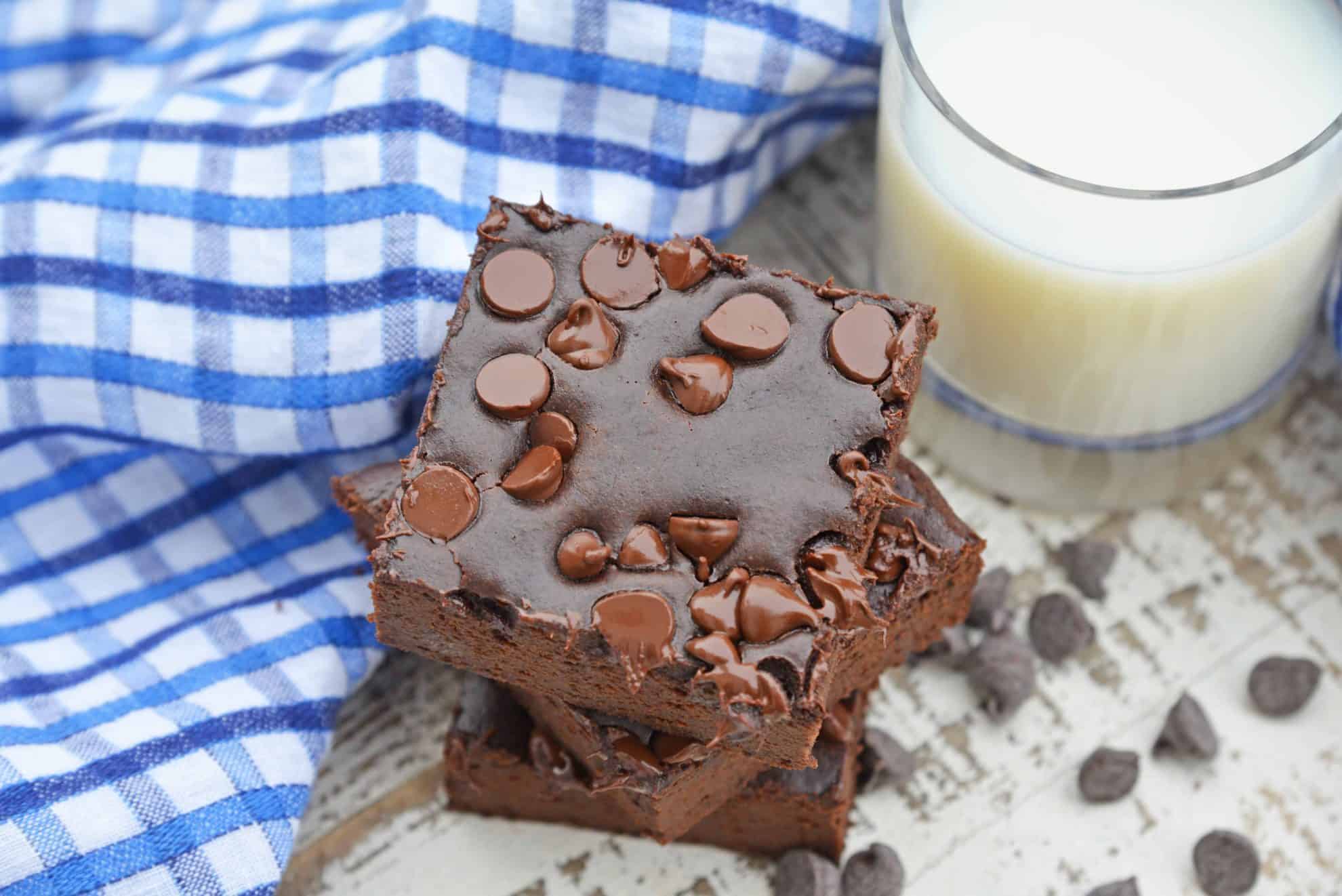 Stack of Flourless Black Bean Brownies with a glass of milk