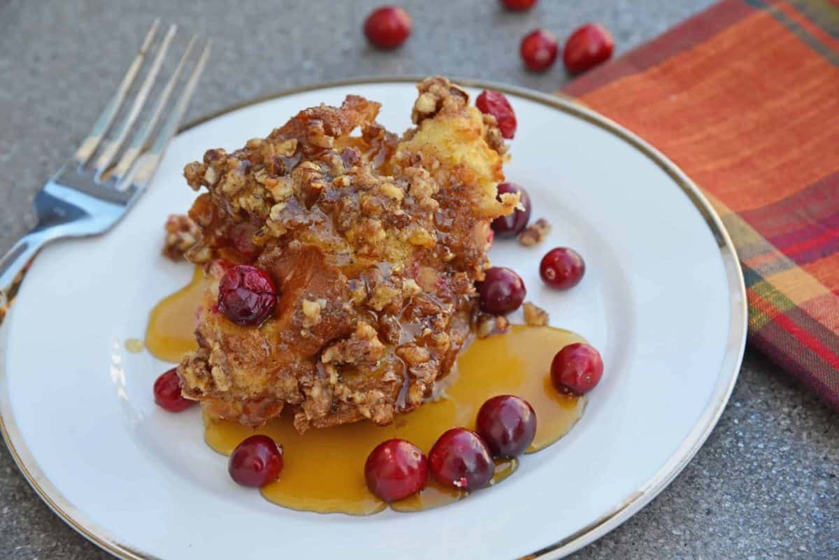 Cranberry French Toast Casserole is one of the best recipes using cranberries you'll ever make! A French toast casserole perfect for Christmas breakfast! #frenchtoastcasserole #christmasbreakfast #recipesthatusecranberries www.savoryexperiments.com