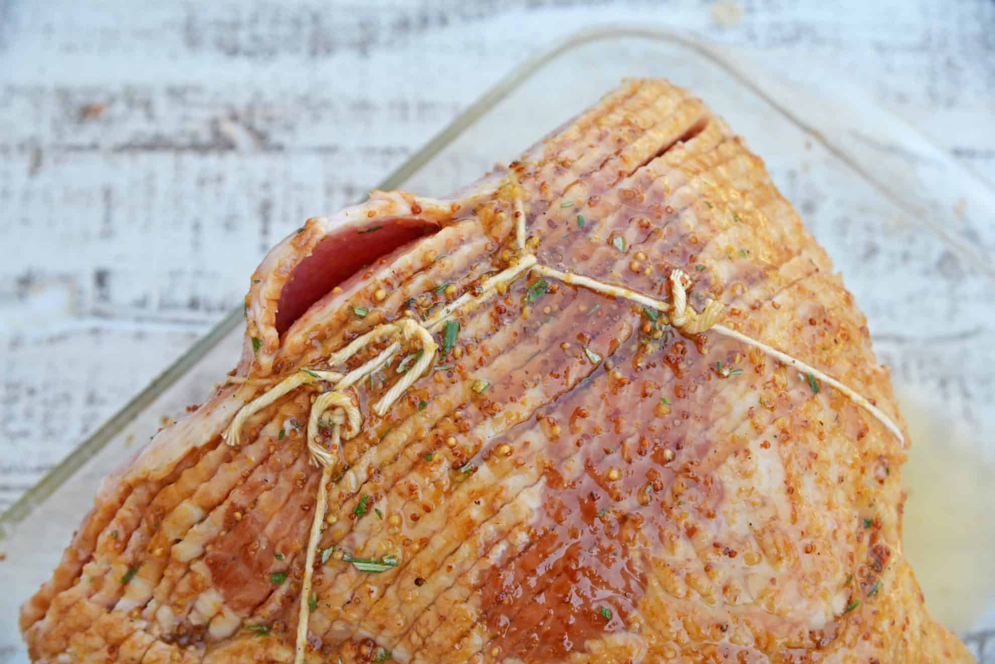 Mustard Brown Sugar Baked Ham is a ham glaze recipe that's perfect for a Christmas ham or an Easter ham. One of the best easy ham recipes! #hamglazerecipe #spiralhamrecipes #easterham #christmasham www.savoryexperiments.com