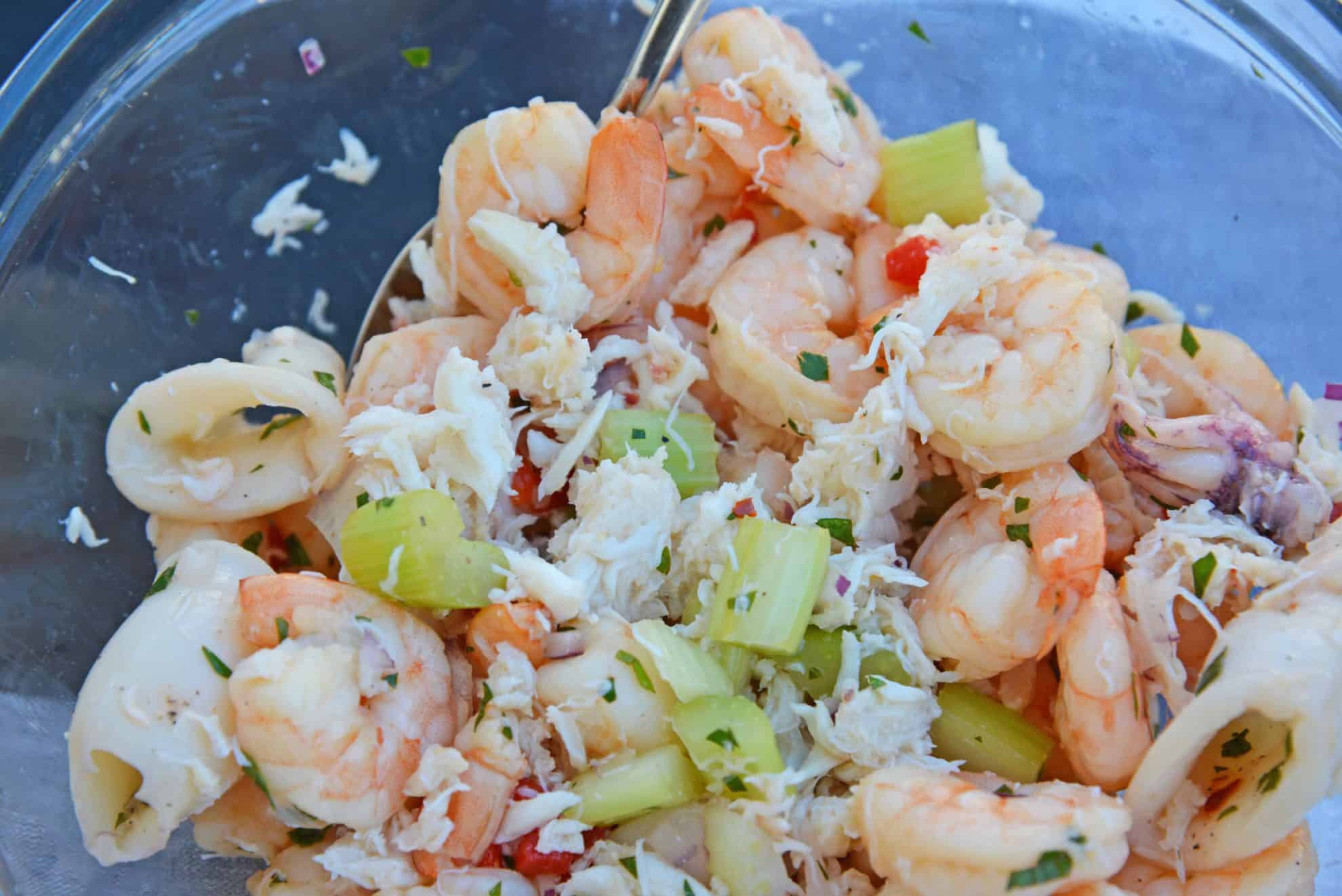 This Italian Seafood Salad, made with shrimp, calamari and lump crab meat, is one of the best and easiest seafood salad recipes you'll ever try.  #seafoodsalad #italianseafoodsalad www.savoryexperiments.com