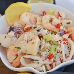 This Italian Seafood Salad, made with shrimp, calamari and lump crab meat, is one of the best and easiest seafood salad recipes you'll ever try. #seafoodsalad #italianseafoodsalad www.savoryexperiments.com