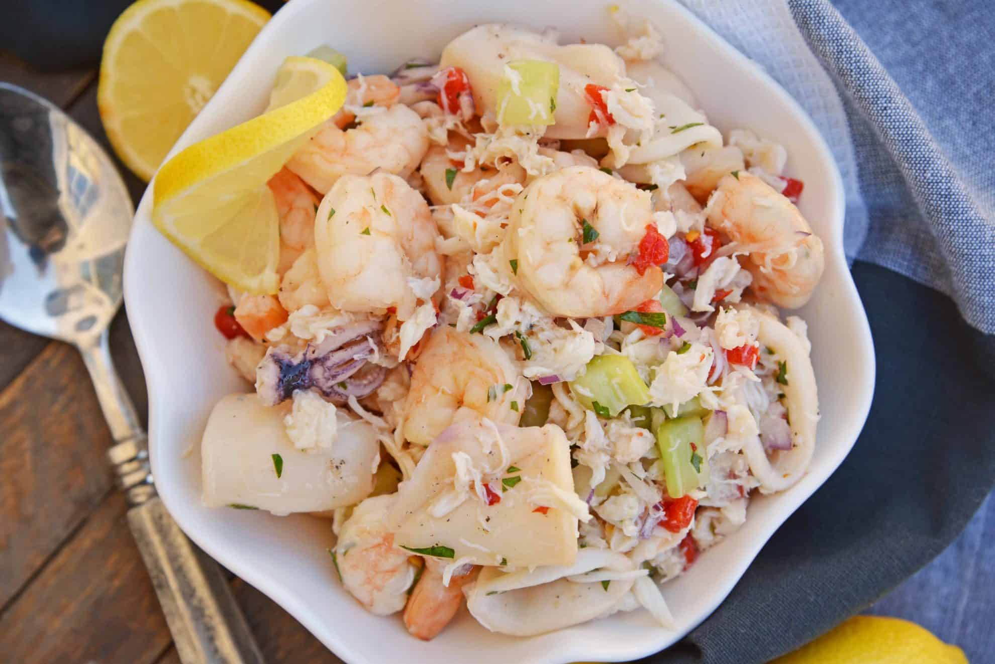 This Italian Seafood Salad, made with shrimp, calamari and lump crab meat, is one of the best and easiest seafood salad recipes you'll ever try.  #seafoodsalad #italianseafoodsalad www.savoryexperiments.com