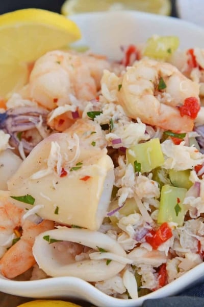 This Italian Seafood Salad, made with shrimp, calamari and lump crab meat, is one of the best and easiest seafood salad recipes you'll ever try. #seafoodsalad #italianseafoodsalad www.savoryexperiments.com