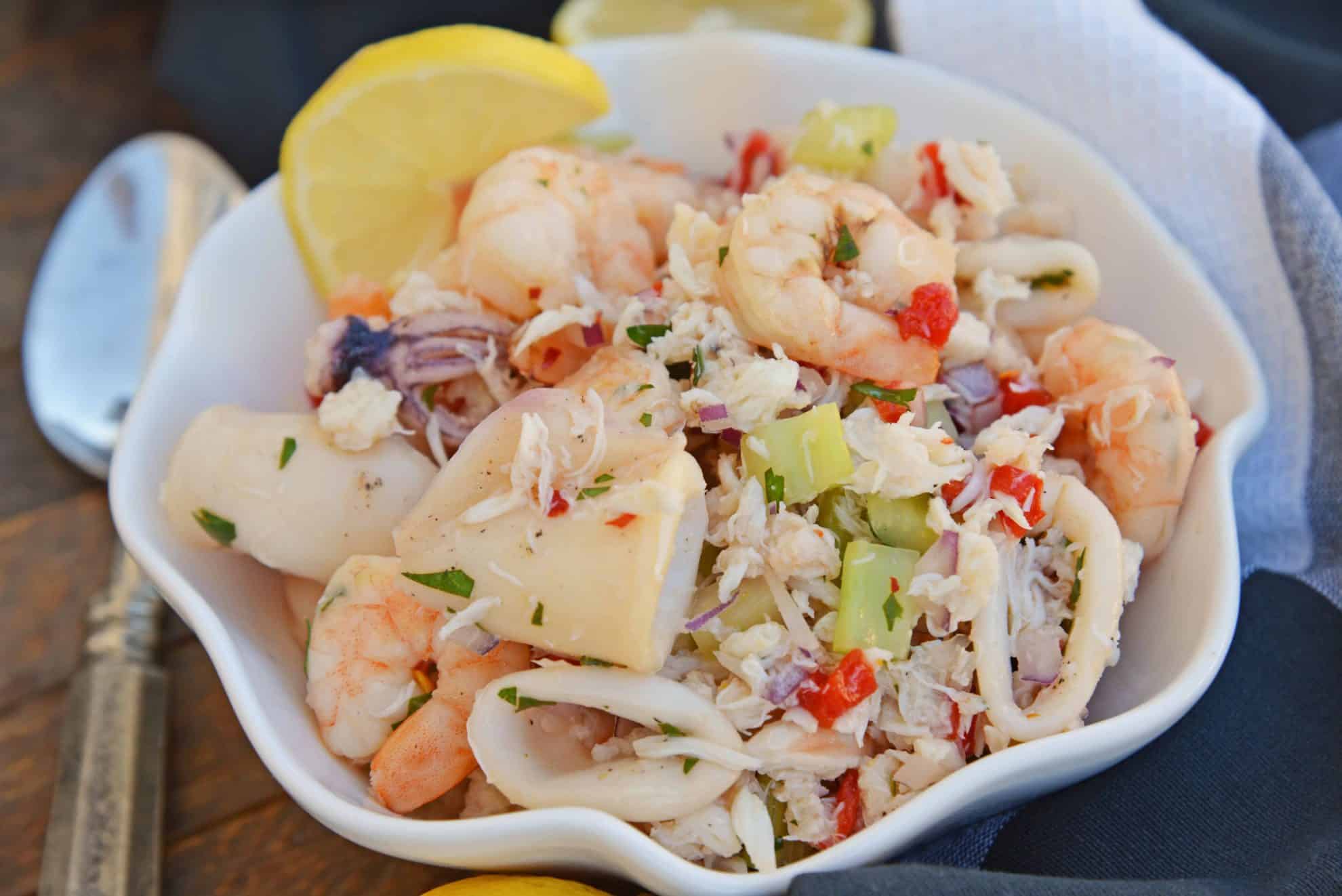 This Italian Seafood Salad, made with shrimp, calamari and lump crab meat, is one of the best and easiest seafood salad recipes you'll ever try.  #seafoodsalad #italianseafoodsalad www.savoryexperiments.com