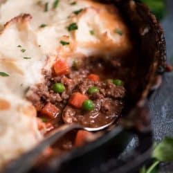 Shepherd's pie in a skillet with a spoon - skillet dinners