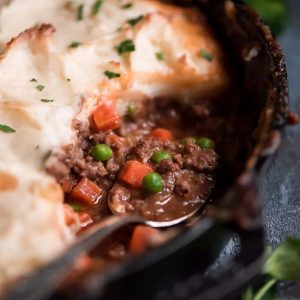 Shepherd's pie in a skillet with a spoon - skillet dinners
