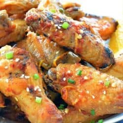 close up of sticky orange chicken wings