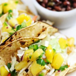 angled shot of tilapia tacos on plate