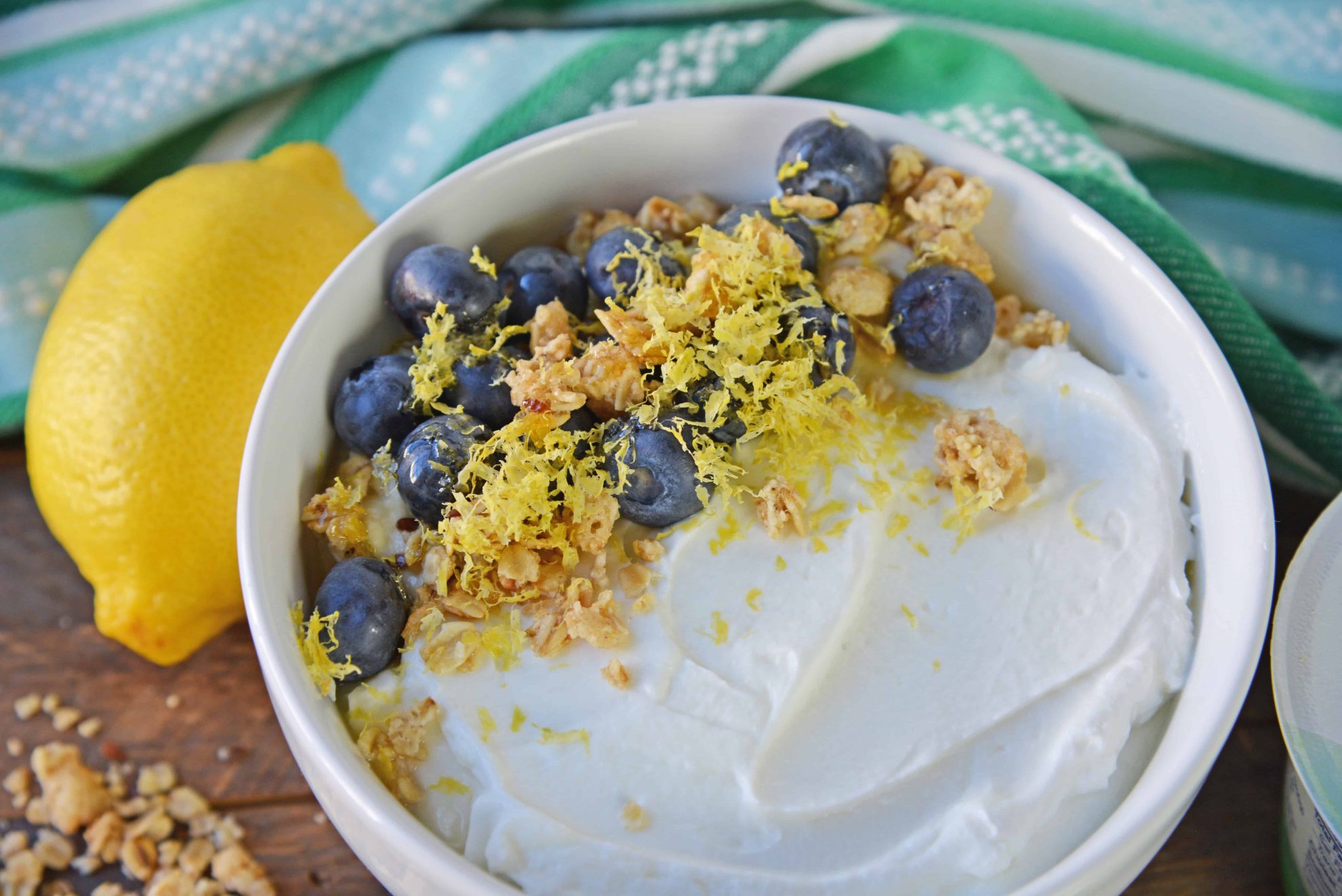 bowl of yogurt with blueberries, lemon and granola 