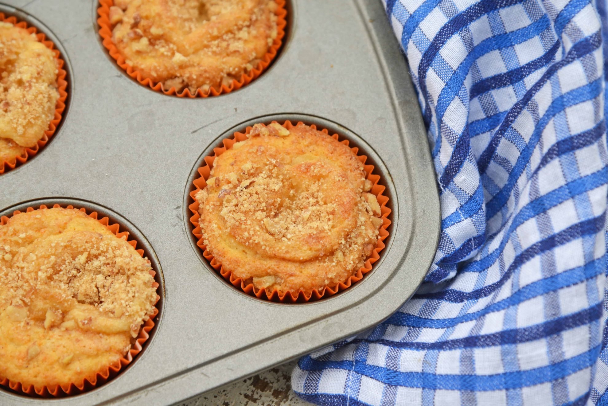 Carrot Cake Muffins are muffins loaded with carrots and stuffed with cream cheese frosting. Perfect for breakfast, brunch or a snack. Also freezer-friendly!  #carrotcakemuffins www.savoryexperiments.com 