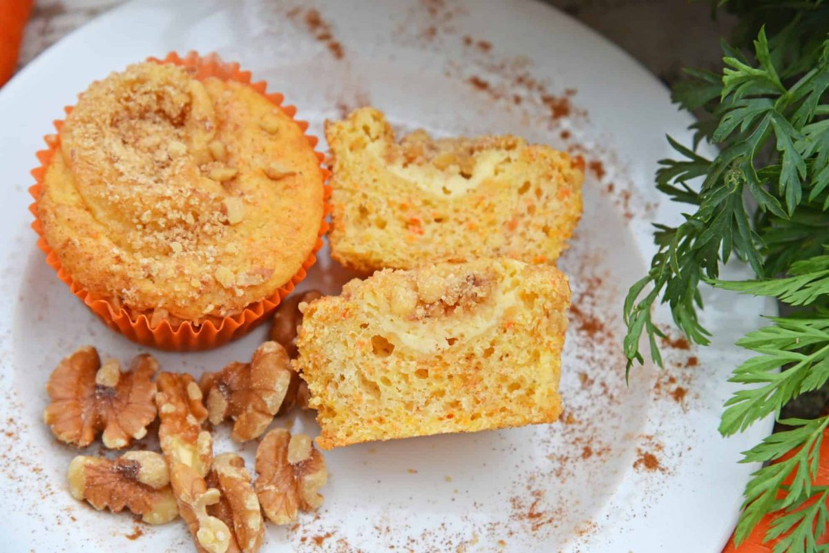 Carrot Cake Muffins are muffins loaded with carrots and stuffed with cream cheese frosting. Perfect for breakfast, brunch or a snack. Also freezer-friendly!  #carrotcakemuffins www.savoryexperiments.com