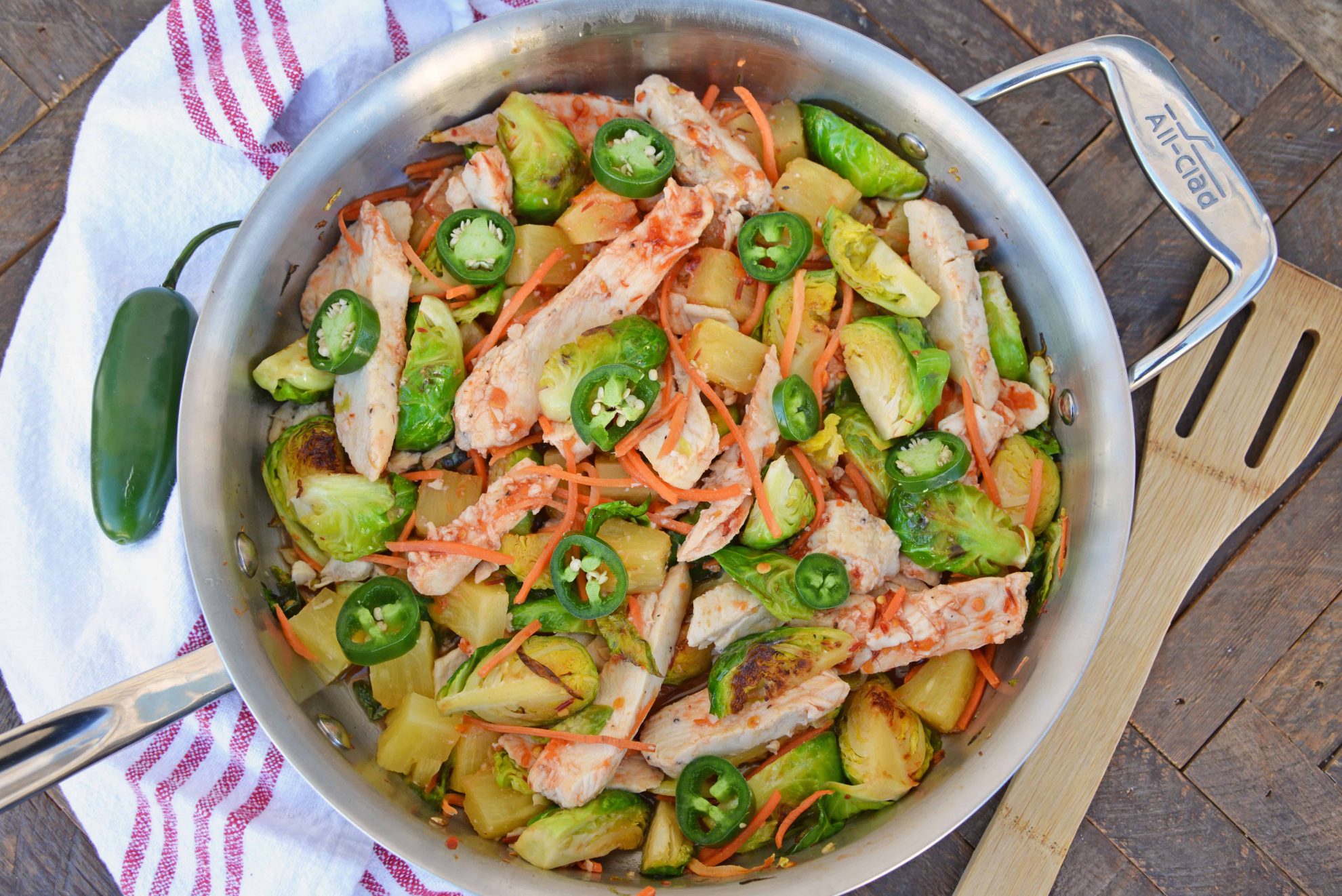 Quick Szechuan Chicken and Rice is an easy dinner recipe featuring chicken strips, brussels sprouts, carrots and pineapple over brown rice. All ready in 15 minutes! #quickchickendinners #szechuanchicken www.savoryexperiments.com 
