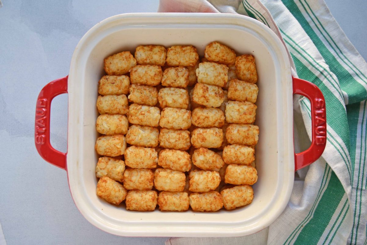 tater tots layered in baking dish