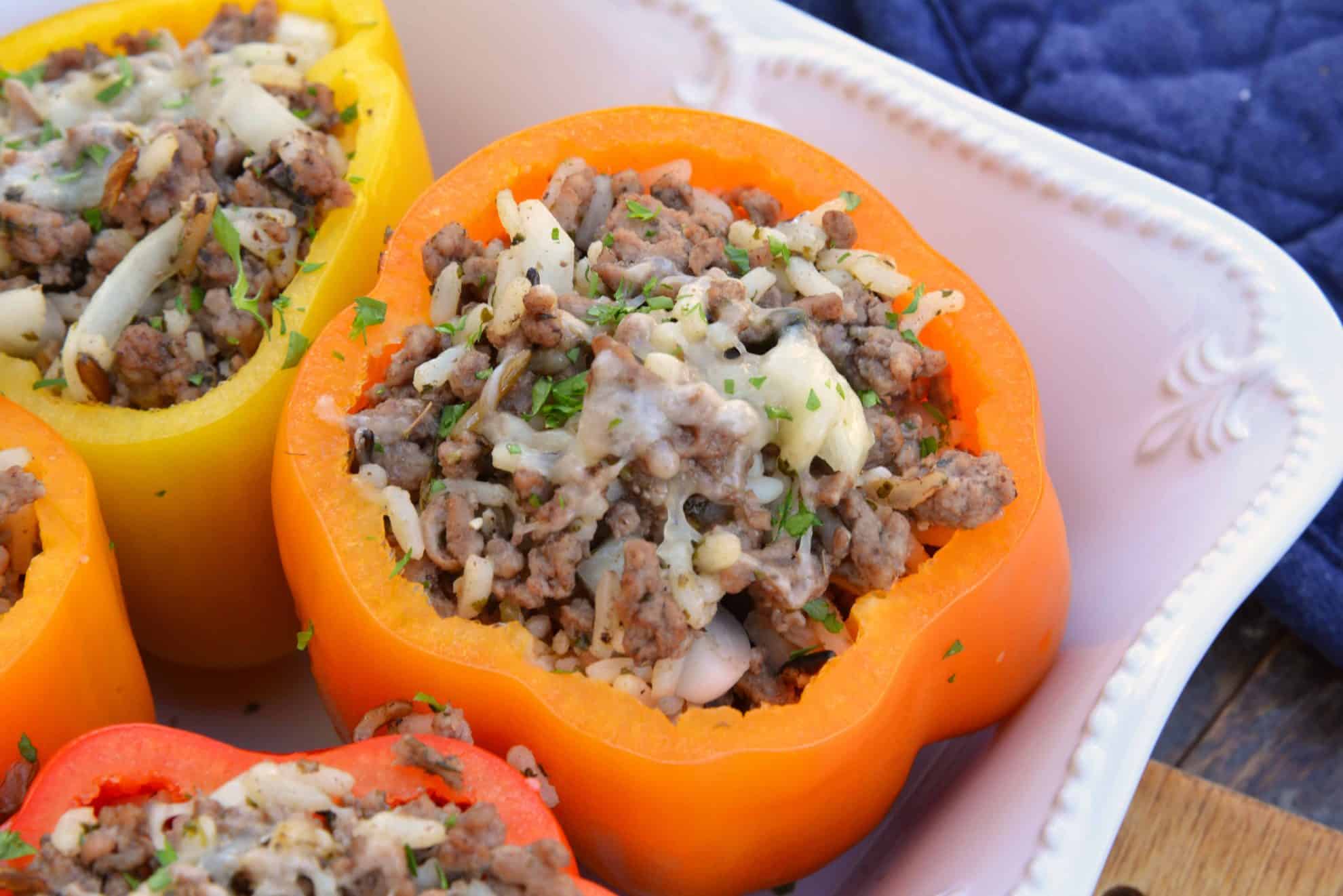 Classic Stuffed Peppers are bell peppers stuffed with ground beef, rice, cheese and spices. A timeless meal ready in 30 minutes and easily made ahead. #stuffedpeppers #stuffedbellpeppers www.savoryexperiments.com 