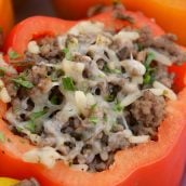 Classic Stuffed Peppers are bell peppers stuffed with ground beef, rice, cheese and spices. A timeless meal ready in 30 minutes and easily made ahead. #stuffedpeppers #stuffedbellpeppers www.savoryexperiments.com
