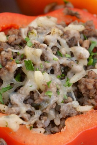 Classic Stuffed Peppers are bell peppers stuffed with ground beef, rice, cheese and spices. A timeless meal ready in 30 minutes and easily made ahead. #stuffedpeppers #stuffedbellpeppers www.savoryexperiments.com