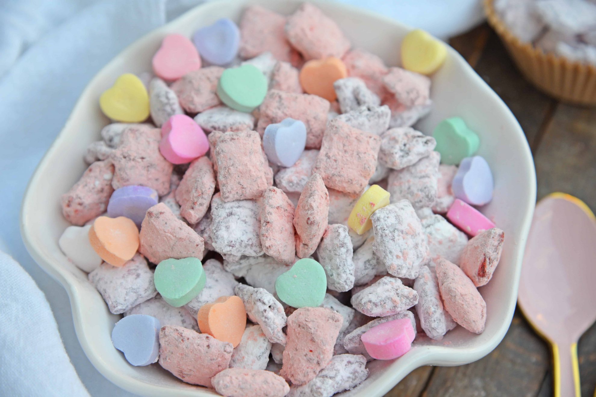 Valentine's Day Puppy Chow transforms a traditional muddy buddy recipe into a festive Cupid Crunch mix! The perfect no-bake dessert for any Valentine's Day party. #puppychow #valentinesdaydesserts #muddybuddy #nobakedesserts www.savoryexperiments.com