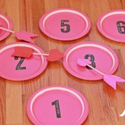 A wooden table topped with plates of food on a plate, with Craft and Valentine's Day