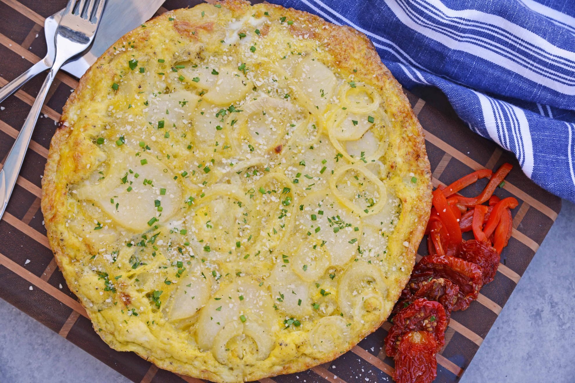 Tortilla Espanola, also known as Spanish Tortilla or Potato Tortilla, is a Spanish egg dish made with fried potatoes, onions and cheese. #tortillaespanola #spanishtortilla #potatotortilla www.savoryexperiments.com 