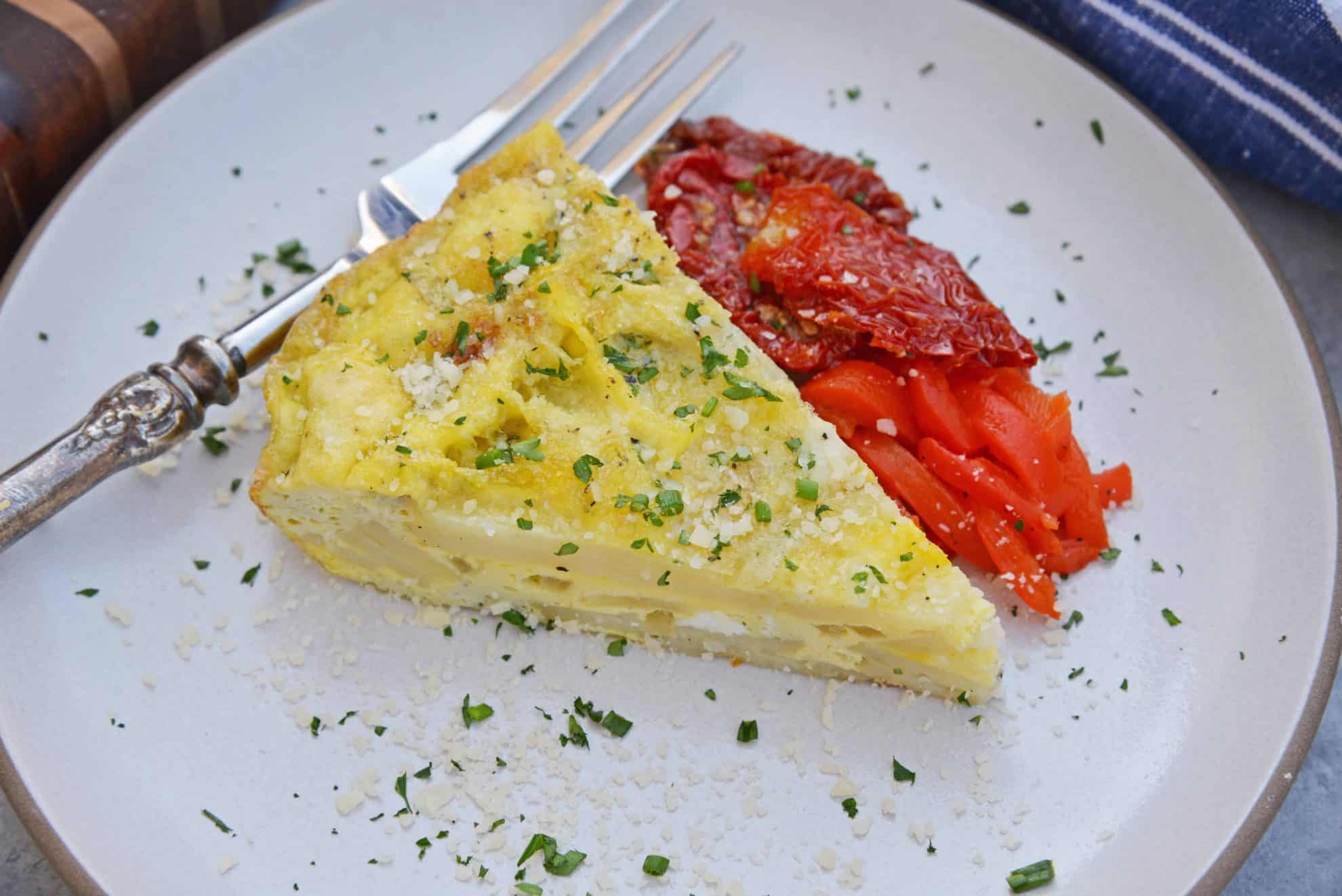 Tortilla Espanola, also known as Spanish Tortilla or Potato Tortilla, is a Spanish egg dish made with fried potatoes, onions and cheese. #tortillaespanola #spanishtortilla #potatotortilla www.savoryexperiments.com 