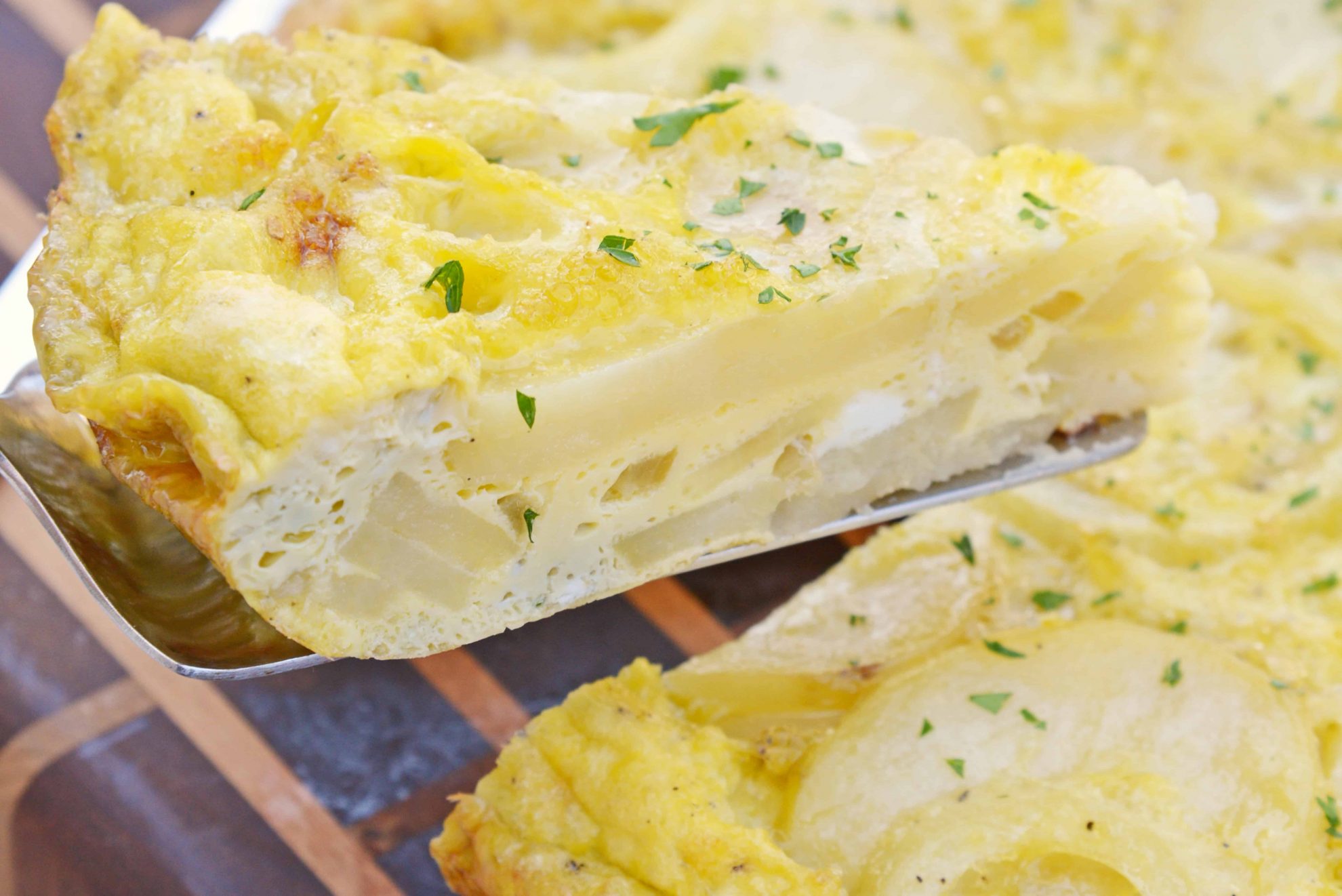 Tortilla Espanola, also known as Spanish Tortilla or Potato Tortilla, is a Spanish egg dish made with fried potatoes, onions and cheese. #tortillaespanola #spanishtortilla #potatotortilla www.savoryexperiments.com 