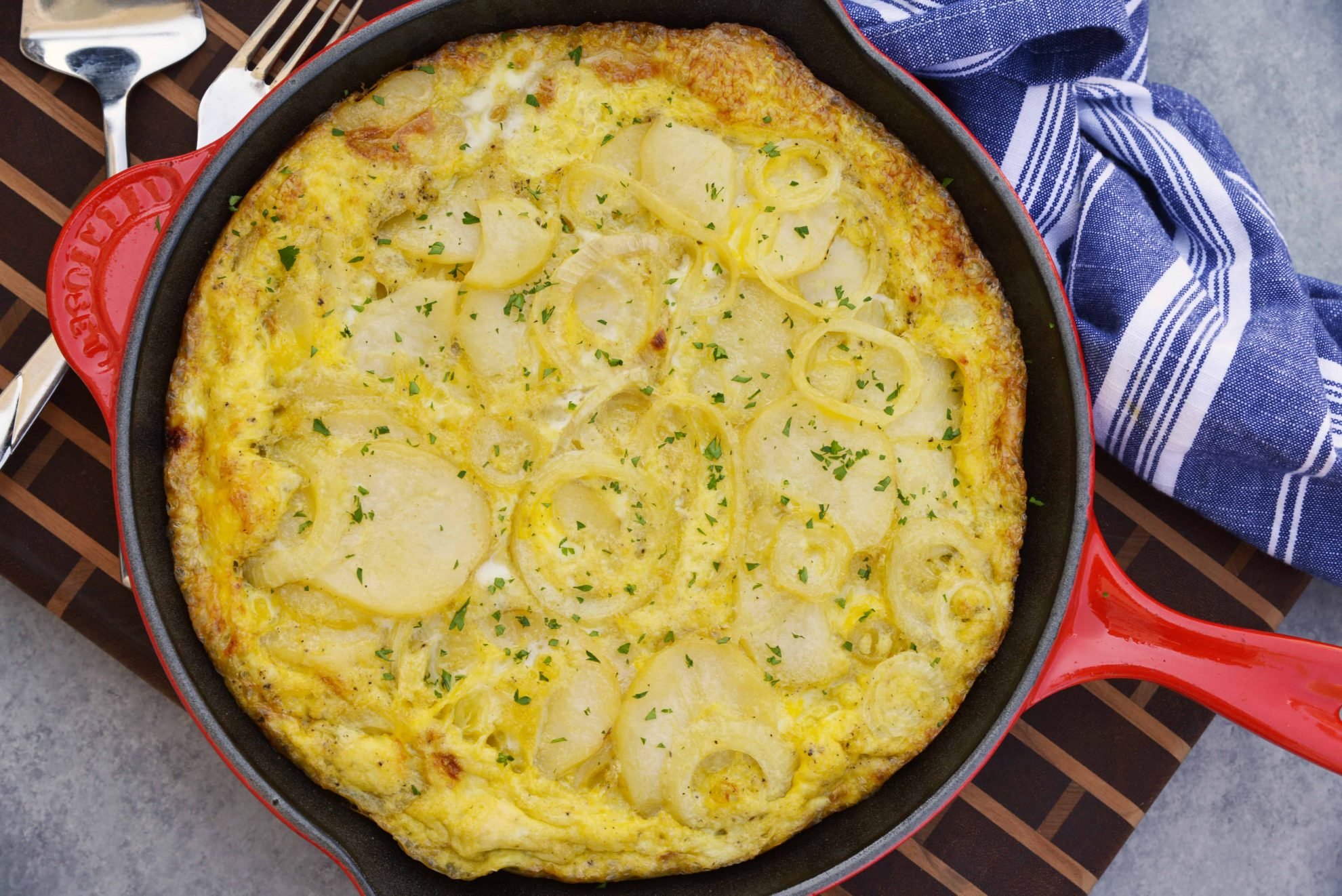 Tortilla Espanola, also known as Spanish Tortilla or Potato Tortilla, is a Spanish egg dish made with fried potatoes, onions and cheese. #tortillaespanola #spanishtortilla #potatotortilla www.savoryexperiments.com