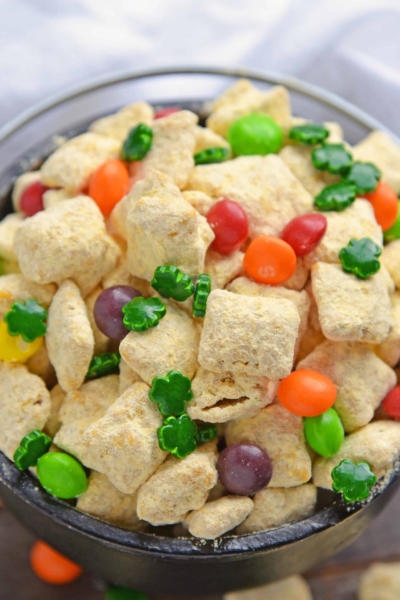 Pot of Gold PUppy Chow is the perfect gold St. Patrick's Day dessert or snack. Easy to make, make-ahead and delicious to eat, it will be the hit of your St. Patrick's Day bash! #puppychowrecipe #stpatricksday #potofgold www.savoryexperiments.com